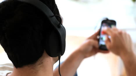 Man-moving-his-head-while-listening-to-music-with-his-phone