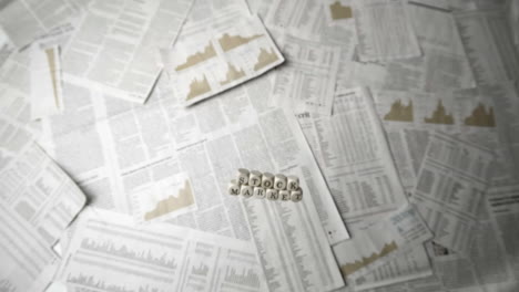 White-dice-spelling-out-stock-market-falling-over-sheets-of-paper