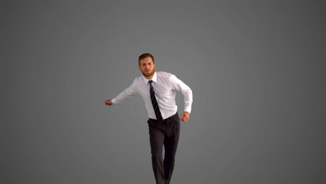 Businessman-jumping-and-clicking-heels-on-grey-background