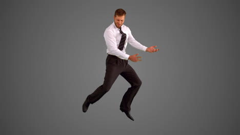 Businessman-leaping-on-grey-background