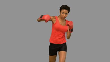 Attractive-woman-boxing-on-grey-screen