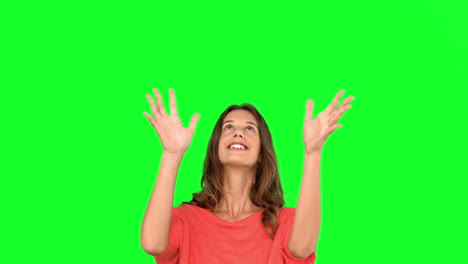 Woman-throwing-a-globe-in-the-air-on-green-screen