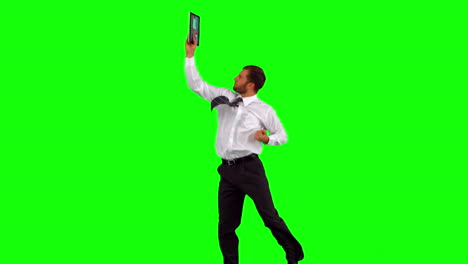 Businessman-holding-tablet-pc-jumping-up