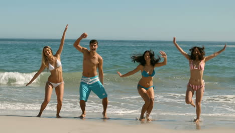Happy-friends-jumping-on-the-beach-