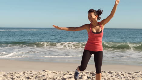 Cheerful-woman-working-out-on-the-beach