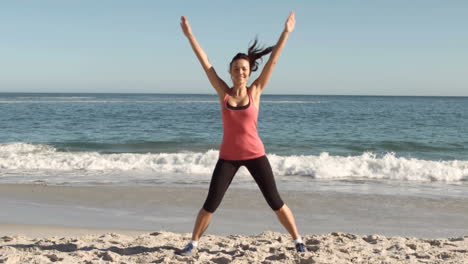 Happy-woman-working-out-on-the-beach