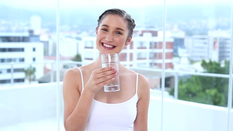 Happy-young-woman-drinking-water