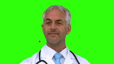 Doctor-throwing-a-pill-in-the-air-on-green-screen