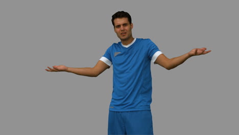 Furious-football-player-gesturing-on-grey-screen