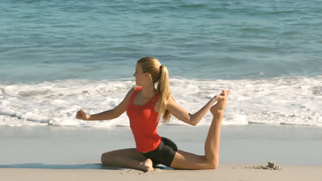 Woman-stretching-her-leg-on-the-beach