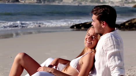Attractive-couple-relaxing-on-the-beach