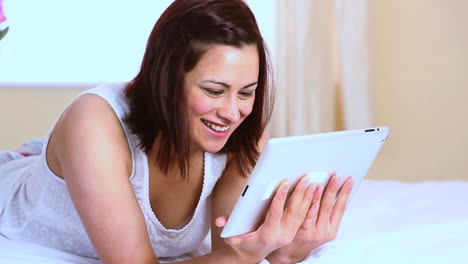 Smiling-woman-using-her-tablet-pc