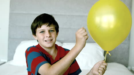 Boy-piercing-his-yellow-balloon-and-getting-a-fright