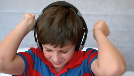 Young-boy-enjoying-music-with-headphones