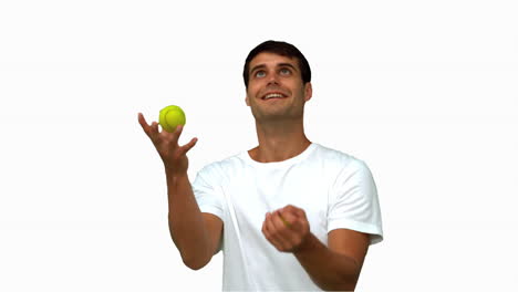 Man-dribbling-with-tennis-balls-on-white-screen