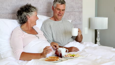 Mature-couple-having-breakfast-together