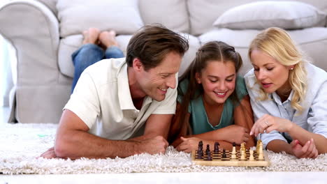 Parents-and-daughter-playing-chess