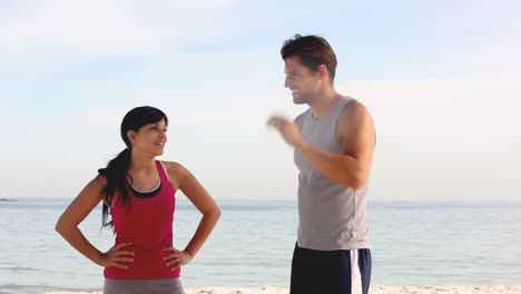 Couple-of-joggers-running-on-the-beach
