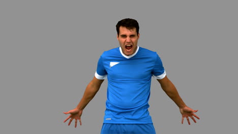 Angry-football-player-holding-his-head-on-grey-screen