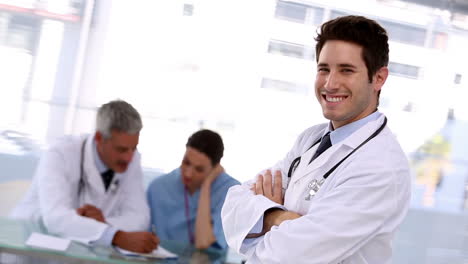 Smiling-doctor-putting-stethoscope-around-his-neck