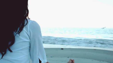 Woman-practicing-yoga-on-the-beach