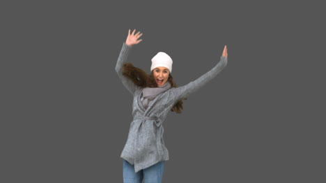 Cheerful-young-model-in-winter-clothes-jumping