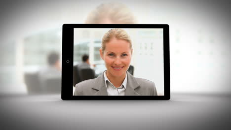 Video-showing-tablet-displaying-business-people
