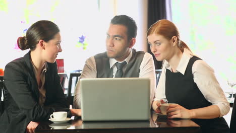 Business-people-working-together-while-having-coffee-in-a-restaurant