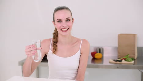 Smiling-model-drinking-glass-of-water