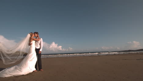 Happy-bridal-couple-kissing-on-the-beach