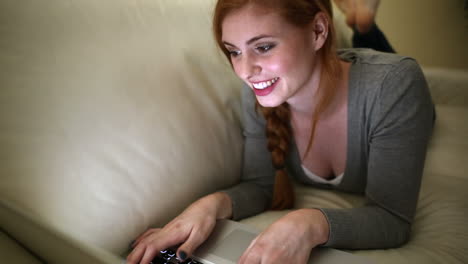 Beautiful-brunette-lying-on-bed-using-laptop