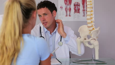 Chiropractor-speaking-with-his-patient