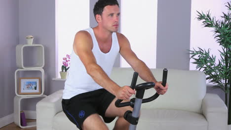 Handsome-sporty-man-training-on-exercise-bike