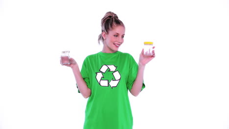Cheerful-female-environmental-activist-showing-two-jam-jars-