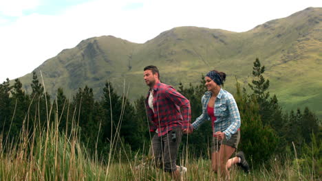 Athletic-couple-running-through-the-countryside