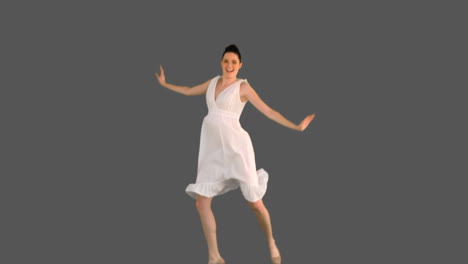 Pretty-young-model-in-white-dress-jumping