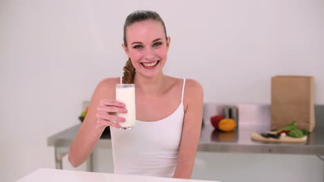 Smiling-model-drinking-glass-of-milk