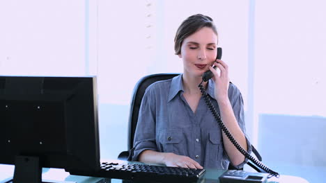 Pretty-businesswoman-answering-phone
