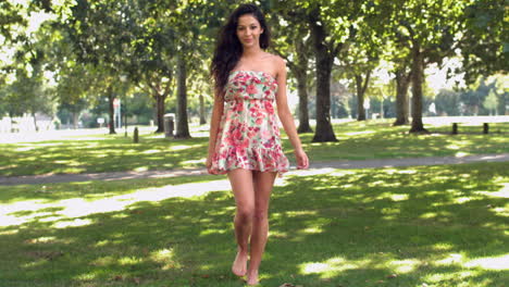 Gorgeous-happy-brunette-walking-in-park