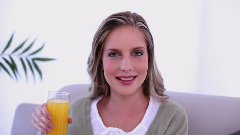 Beautiful-blonde-woman-drinking-a-glass-of-orange-juice-