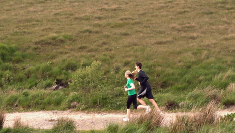 Athletic-couple-jogging-in-the-countryside-together