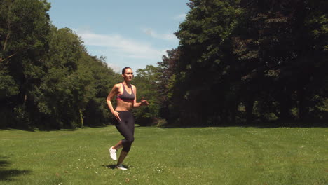 Sporty-brunette-running-on-grass