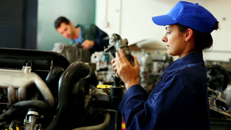 Young-pretty-woman-working-in-a-garage