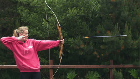Blonde-woman-shooting-bow-and-arrow