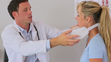 Doctor-fitting-a-neck-brace-on-his-patient