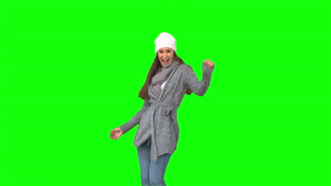 Happy-young-model-in-winter-clothes-dancing