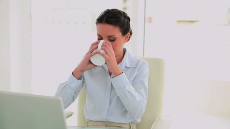Businesswoman-drinking-coffee-and-feeling-revitalized