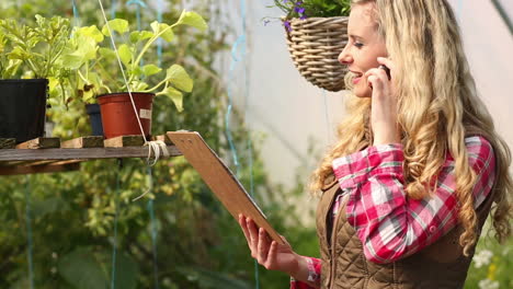 Pretty-blonde-on-the-phone-in-greenhouse
