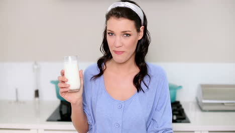 Beautiful-brunette-drinking-a-glass-of-milk