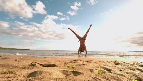 Woman-doing-cartwheel-at-the-beach